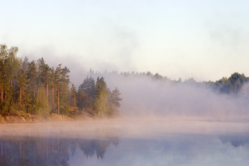 Obraz na płótnie Canvas Fog at a dawn on lake in Kareliya