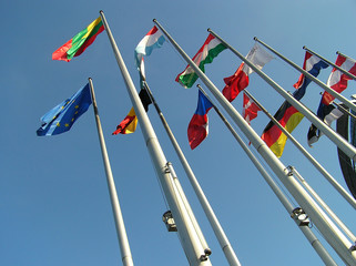 The flags of some countries on background blue sky..