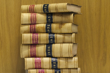 A stack of old law reports against a wood background