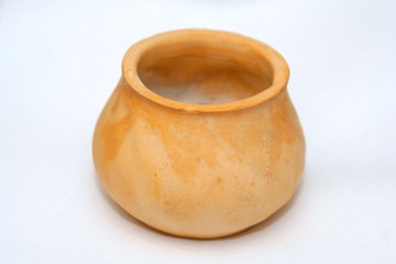 Little orange ceramic pot isolated on the white background