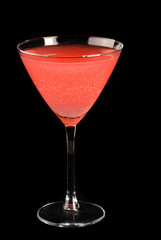 A watermelon martini cocktail on a black background