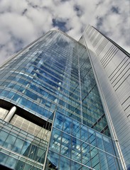 Skyscraper under cloudy sky