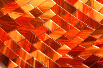 Background of mosaic tiles, glowing in amber tones.
