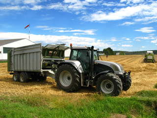 silberfarbener Traktor auf Getreidefeld