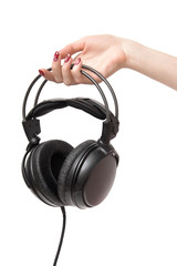 Woman holding headphones. Isolated on white.