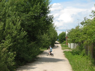 A boy on a bicycle rode on the road