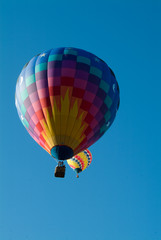 Two Hot Air Balloons rising into a clear Vermont Sky