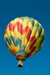 Colorful Hot Air Balloon ascending into a clear blue sky