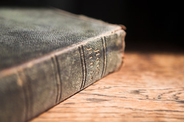 Leather covered old bible lying on a wooden table  - 3738302