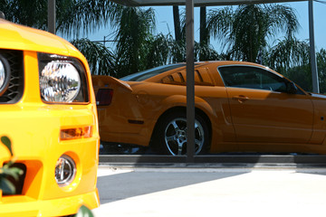 reflection of an orange american muscle car