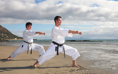 Young adult men with black belt practicing a Kata 