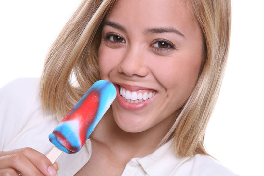 A Pretty Young Woman Eating A Popsicle