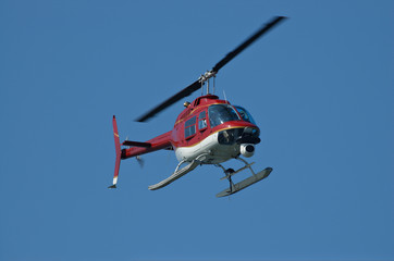 A bright red helicopter with a camera. 