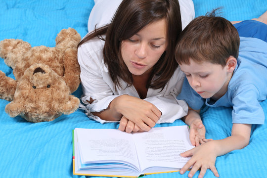 Mother And Five Years Old Boy Reading Book - Good Night