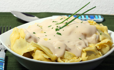 a plate of italian pasta with mushroom cream sauce