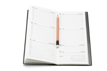 Pencil on Pocket Planner on White Background