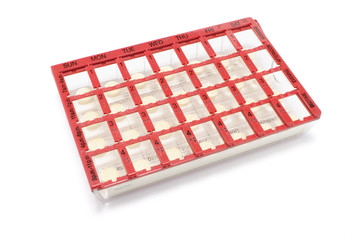 Pills in Pill Box on White Background