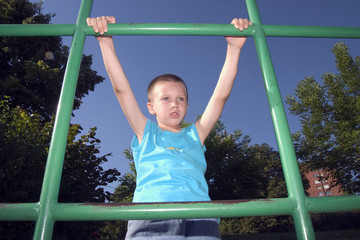 boy is climbing on the green pipes