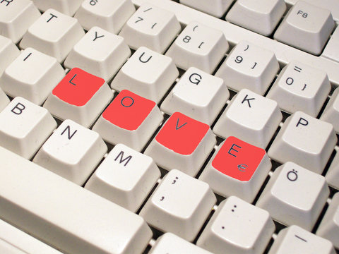 Keys on a computer keyboard to spell out the word love