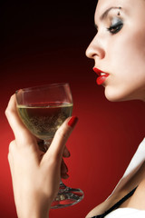women on red is holding a glass of white wine