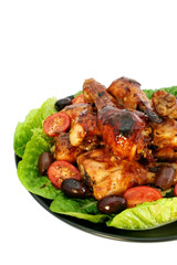 Platter of barbecued chicken pieces, isolated on white.