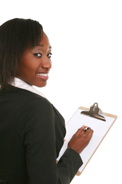 A Pretty Business Woman Writing On A Clipboard