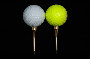 Two golf balls and tees
