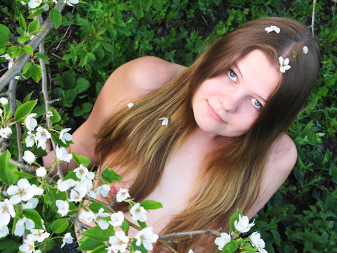 Pretty nude girl with flowers of apple.
