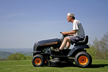 man sitting on lawn mower