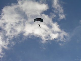 background with a paradigler in a cloudy sky