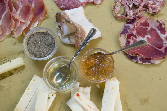 Typical italian salumi, various chesses an some mostard 