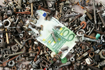100 euro  cash and rusty screws. Manufacturing concept