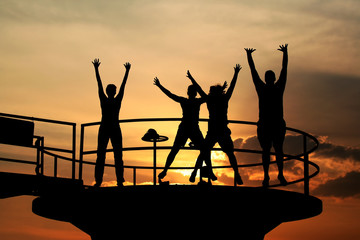 Happy people jumping silhouettes. Happiness concept