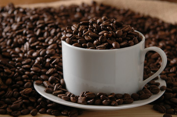 A coffee cup full of fresh beans