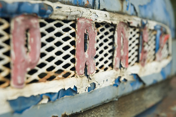 Blue old-fashioned rusty front mask of ancient car Praga V3S.