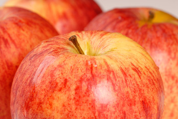Four organic gala apples with a shallow depth of field