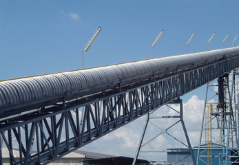 Enclosed conveyor belt leading up to a production plant