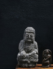 Two Buddha images on a black background - travel and tourism.