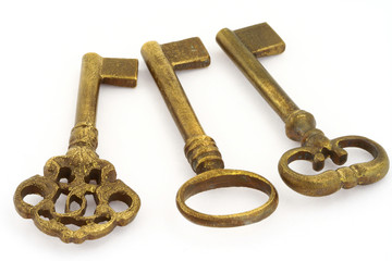 close-up of three ornamented old keys isolated on white 