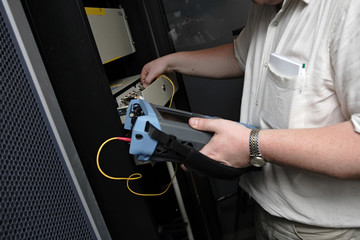 Engineer of telecom tests optical transmission line