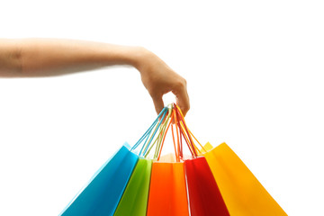 A woman hand carrying a bunch of shopping bags