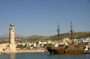 Fototapeta premium Chania harbor in Crete, Greece with lighthouse schooner