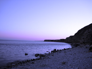 blue sky and rocks on a beach of sea