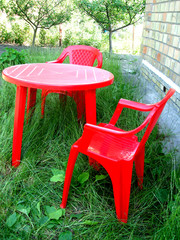 red chairs and table on garden (outdoor living)
