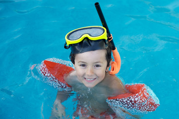 photo of an adorable boy learning to swim