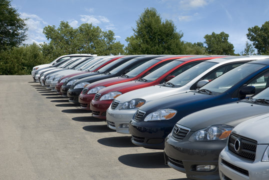 Fototapeta New fuel efficient SUV's on a car dealers lot for sale.