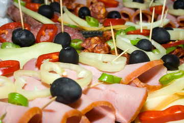 Sliced food; ham, sausage, pepper and olive