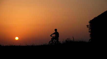 mountain biker silhouette in sunrise