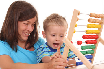 mother and 3-4 years old boy with big abacus isolated on white