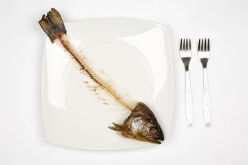 Papier Peint photo Lavable Poisson eaten fish with head and tail - symbol of misery